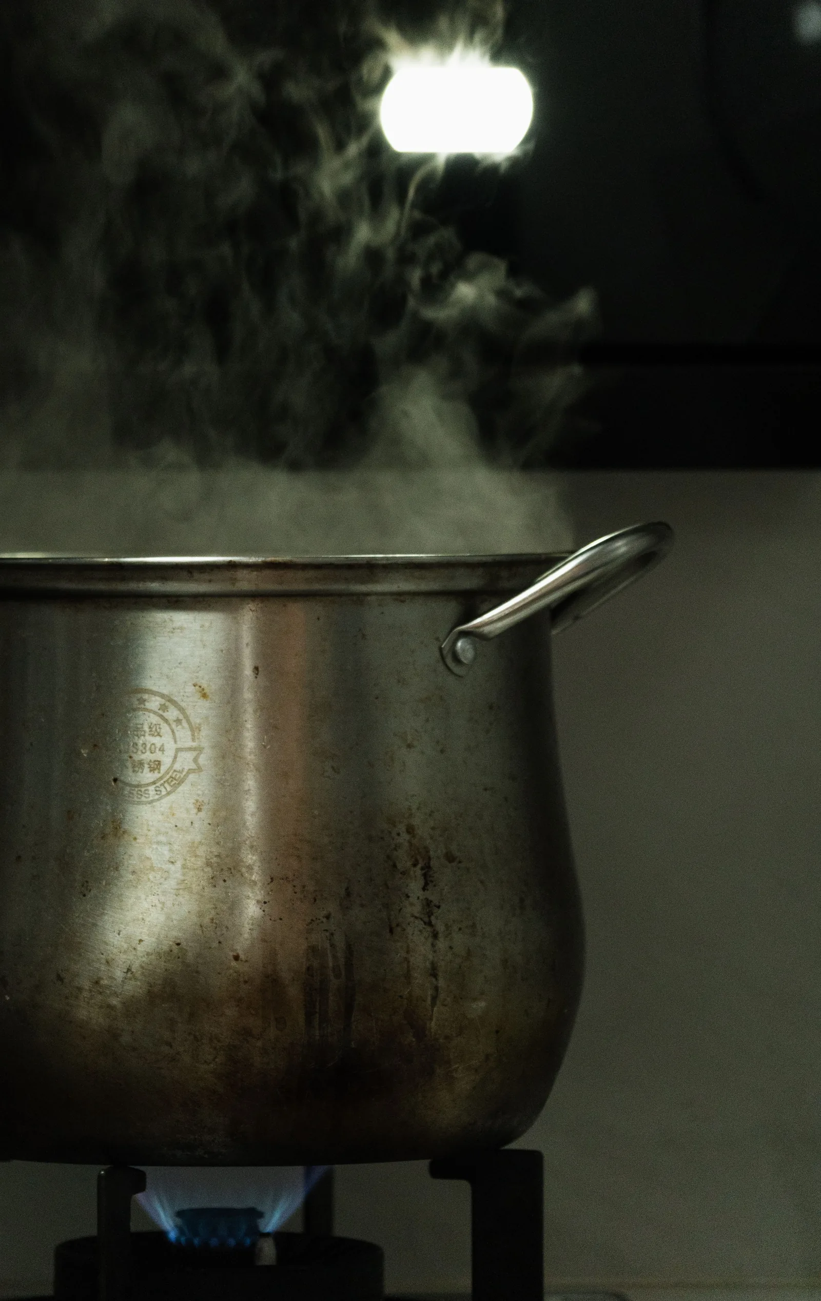 Pot of water boiling on the stove during a boil water advisory