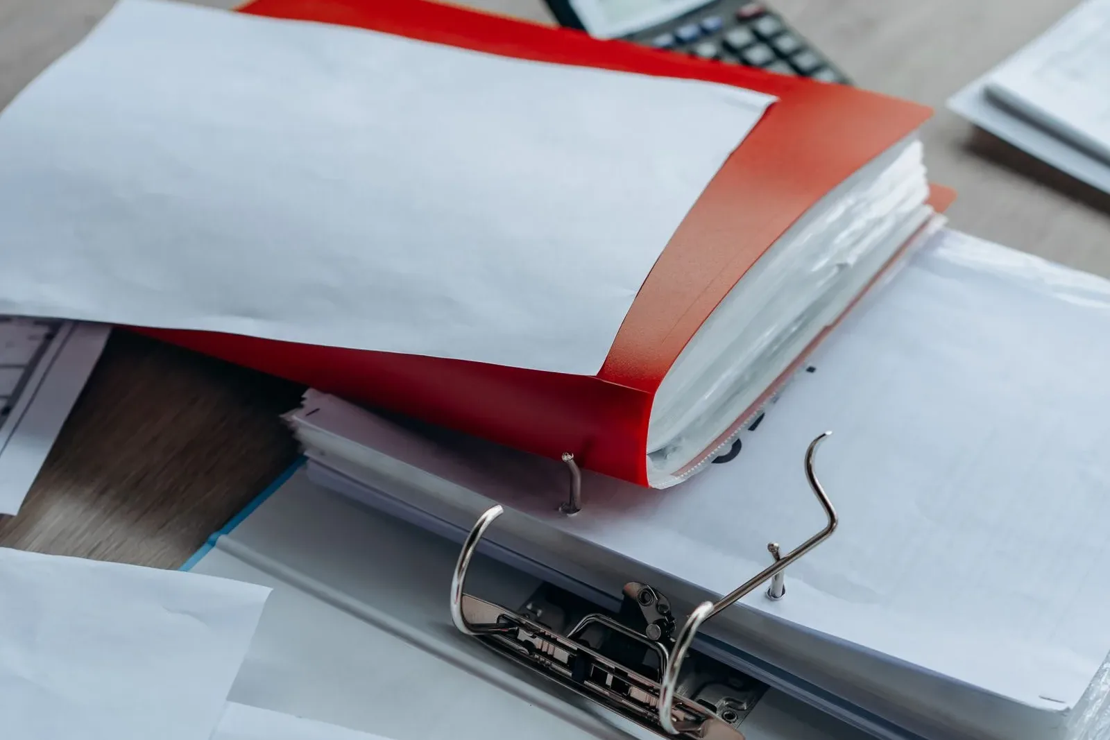 Desk with organized document binders and papers