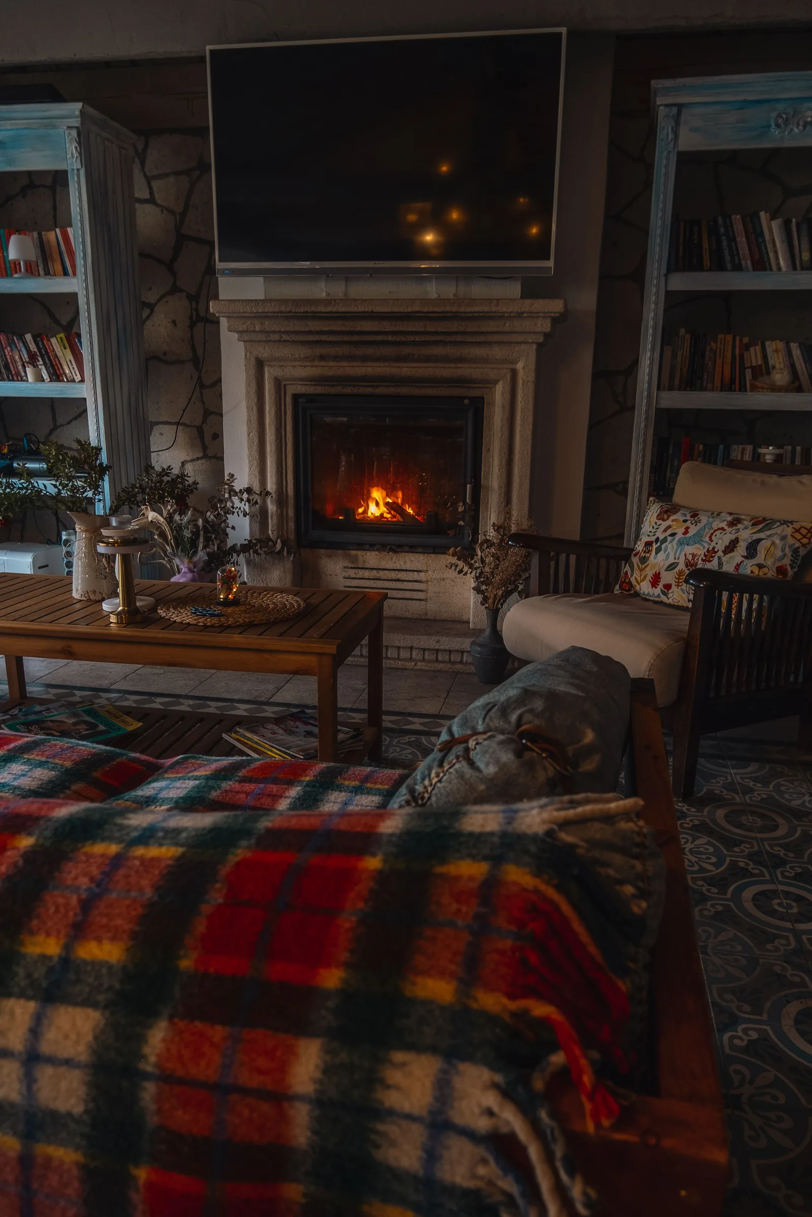 Cozy fireplace and plaid blanket during a winter power outage