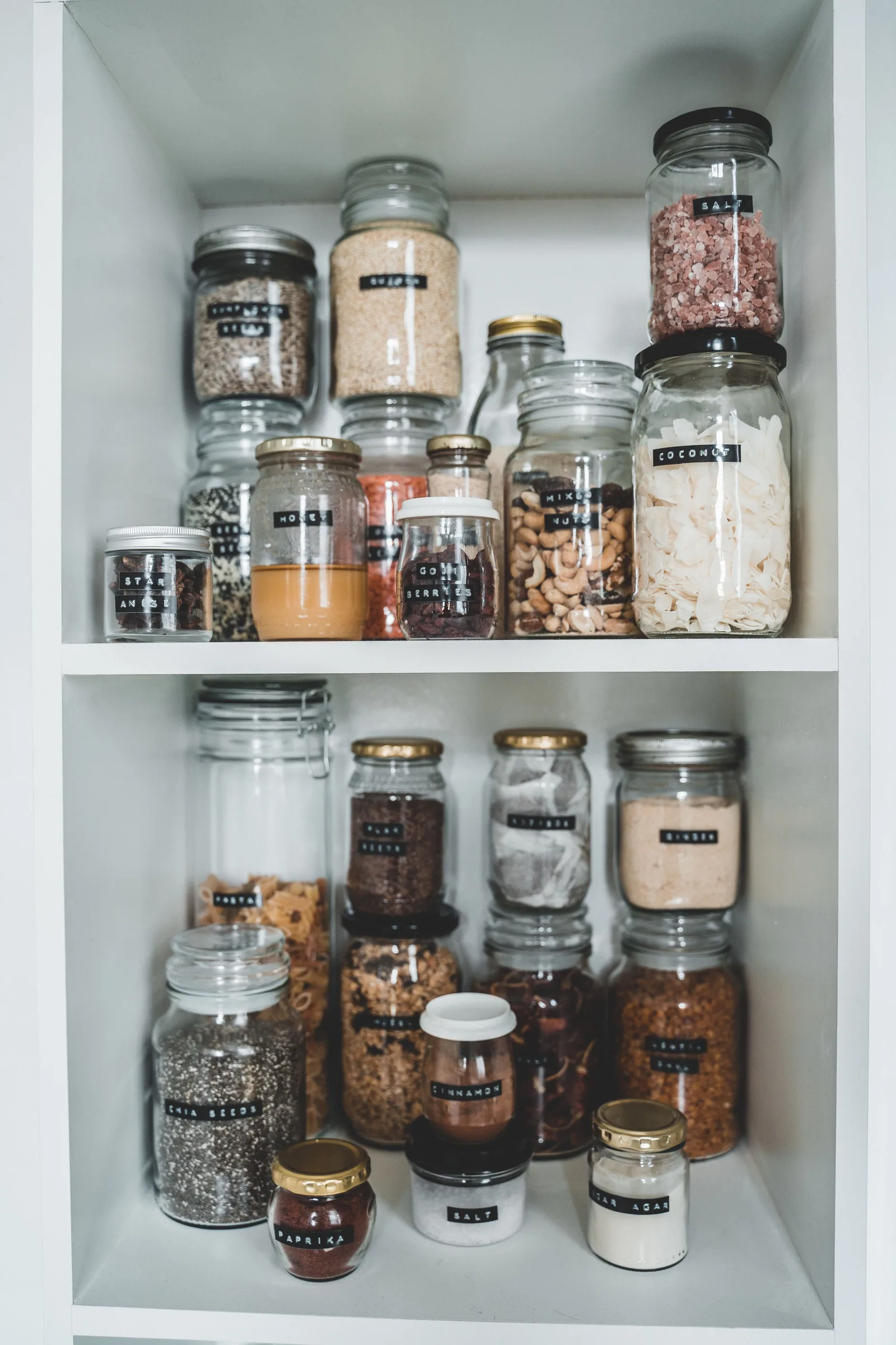 Labeled pantry jars organized for FIFO rotation