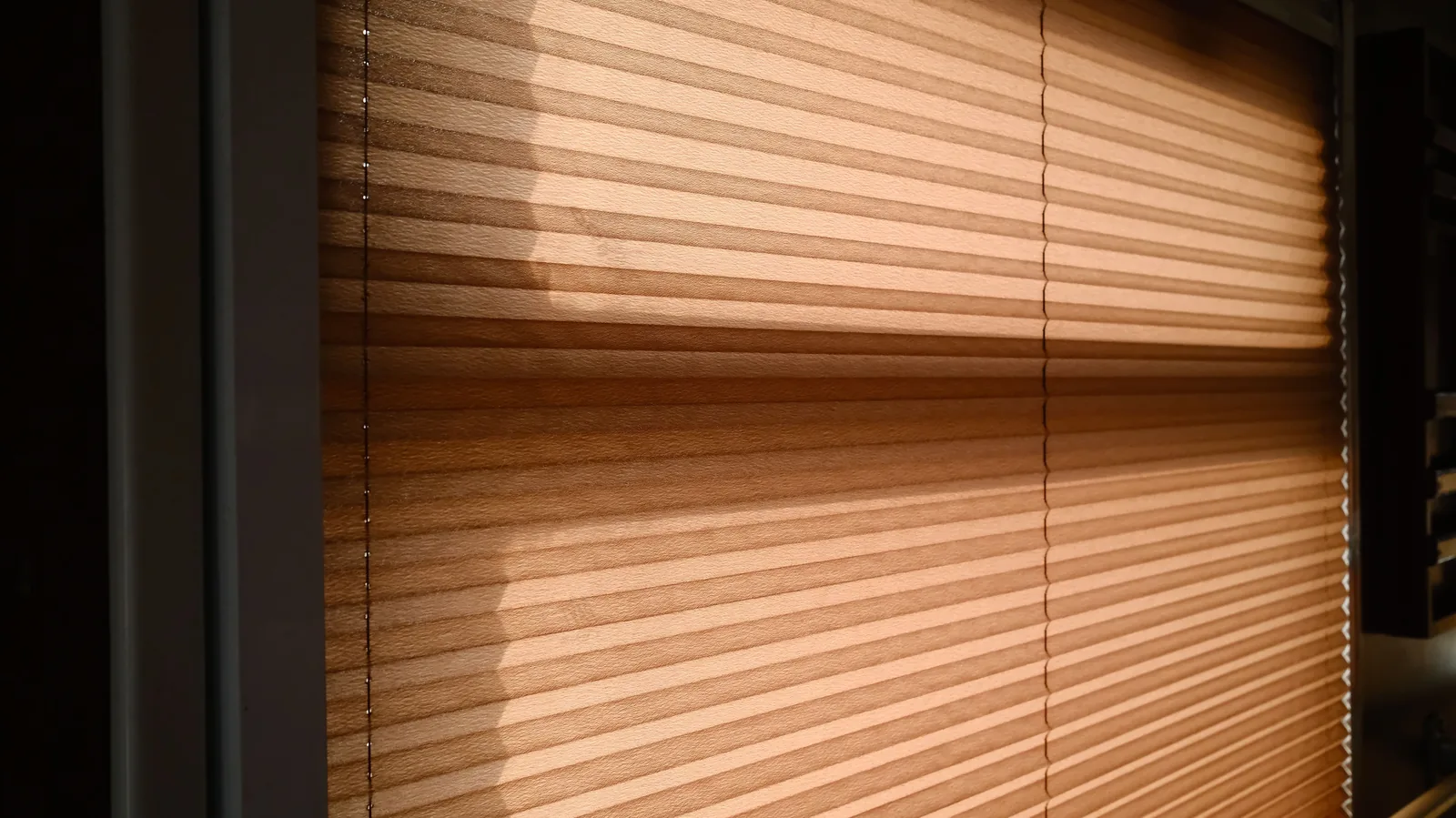 Sunlight through closed blinds on a hot day