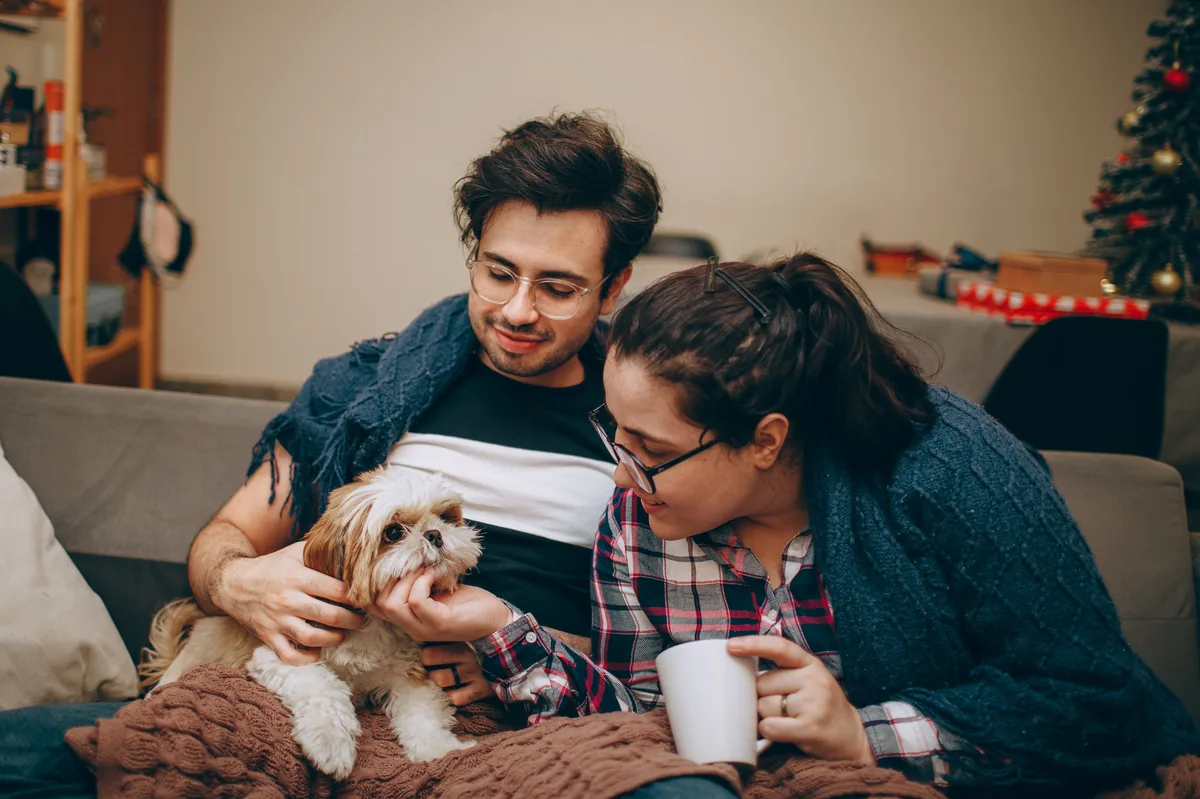 Family bundled in blankets indoors during a cold power outage